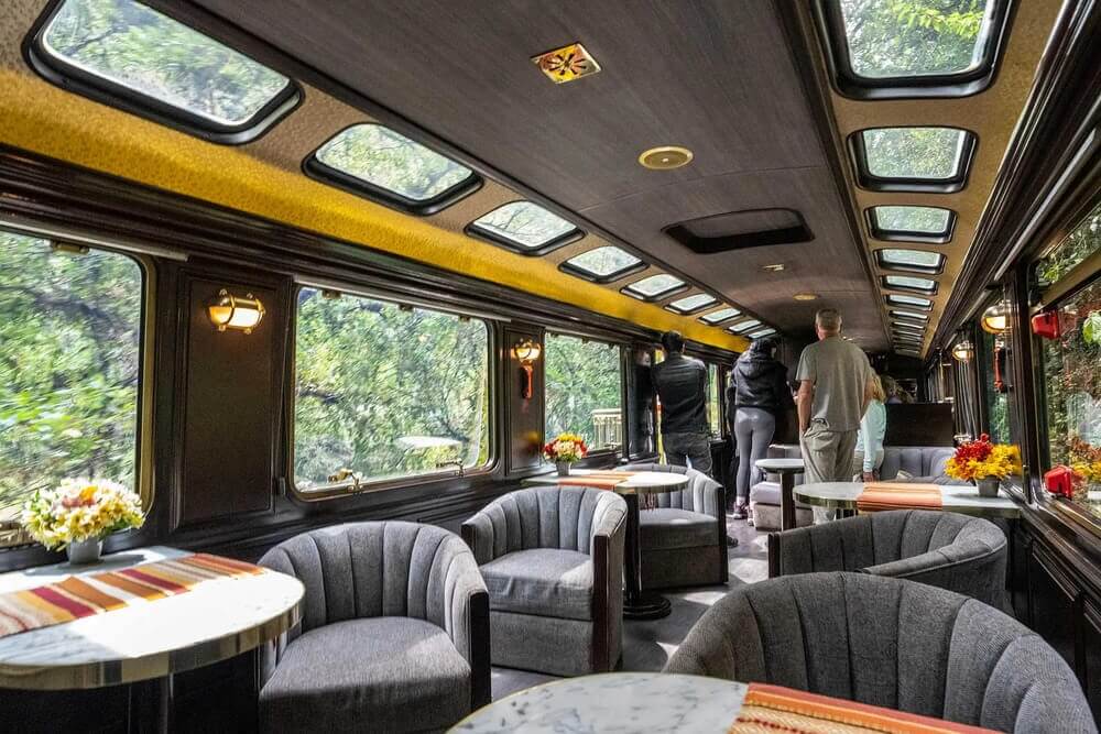 Panoramic view from inside the Vistadome train showing large windows during the journey | Andean Travel Experience
