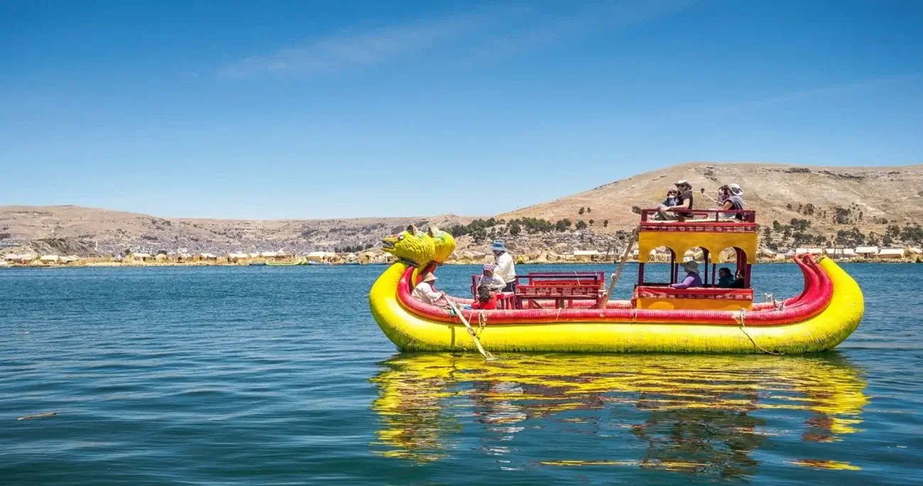 Traditional totora reed boat floating on Lake Titicaca, Peru" | Andean Travel Experience